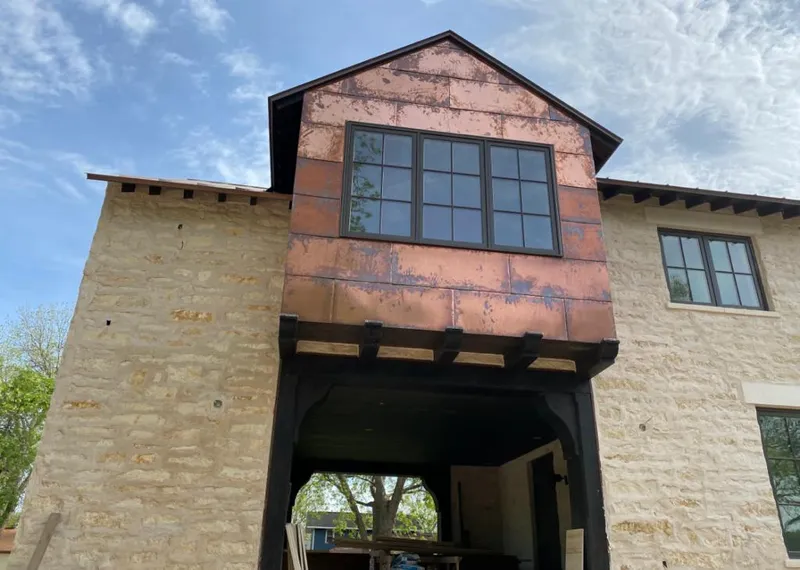 Copper metal panel facade on a stone building for Skylight Installation in Garden Acres